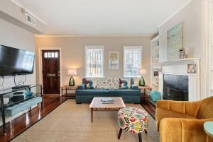 a living room with a blue couch and a tv at Coach`s Corner in Savannah