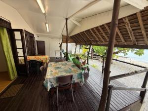 a person sitting at a table on a deck at Chez Aroro Beach House in Avatoru