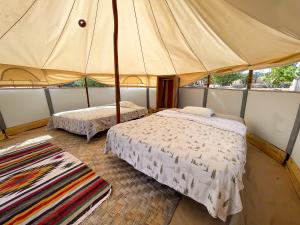 Ένα ή περισσότερα κρεβάτια σε δωμάτιο στο BuenaOnda Eco Glamping