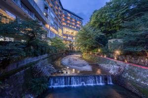 a waterfall in a river in a city at night at Arima Onsen Gekkoen Korokan in Kobe +97 photos