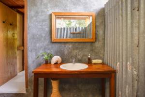 a bathroom with a sink and a mirror at Amy's Place Sumatra in Krui +24 photos