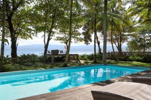 a swimming pool with a view of the ocean at Amy's Place Sumatra in Krui