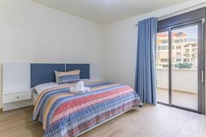 a bedroom with a bed with a teddy bear on it at Serenada 2BR Apartment In Batroun in Batroûn