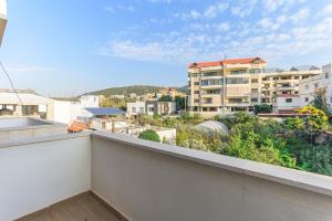 an apartment balcony with a view of a city at Serenada 2BR Apartment In Batroun in Batroûn