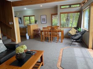 a living room with a couch and a table at Pukawa Villas Formerly Oreti Village Resort in Kuratau
