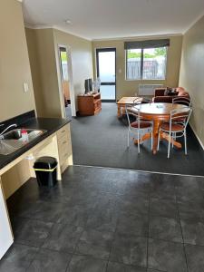 a kitchen and living room with a table and chairs at Woodbourne Tavern and Motel in Renwick