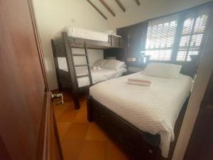 ein Schlafzimmer mit zwei Etagenbetten und einer Leiter in der Unterkunft CABAÑA VILLA OMI in Villa de Leyva
