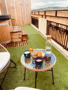 a table with a plate of food and drinks on a balcony at Evasion romantique à Vichy in Vichy