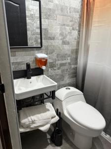 a bathroom with a white toilet and a sink at Suite La Lomita #2 climatizada in Tuxtla Gutiérrez +10 photos