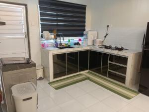 a kitchen with a sink and a counter top at Fawa Homestay Jasin in Jasin