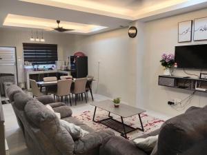 a living room with a couch and a table at Fawa Homestay Jasin in Jasin