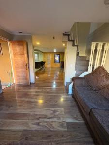 a living room with a couch and a staircase at Alojamiento casa in Temuco