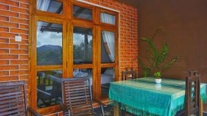a room with a table and chairs and a window at Sigiri Dilu Villa in Sigiriya