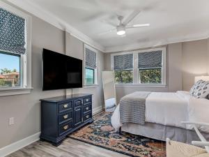a bedroom with a bed and a flat screen tv at Beachside Villa Unit 3 in Tybee Island