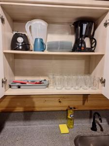 a cupboard filled with dishes and utensils at Cabanas Beach Maresias in São Sebastião