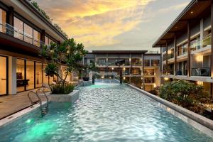 an indoor swimming pool in a building at Kasa Verdana in Chiang Mai