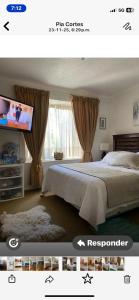 a bedroom with a bed and a flat screen tv at habitaciones exclusivas in Curicó