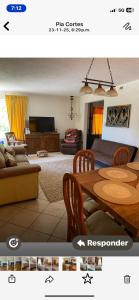 a living room with a table and a couch at habitaciones exclusivas in Curicó