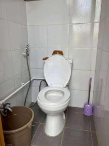 a bathroom with a white toilet in a room at San Juan ELYU Beachfront Cabin in San Juan