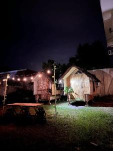 a picnic table in a yard at night with lights at Beach Side Cabin San Juan ELYU in San Juan