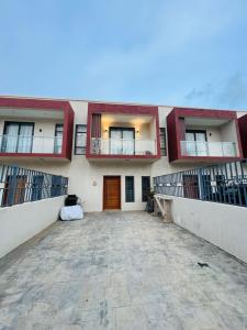 a building with two balconies and a driveway at Gabika Suites in Trofwi