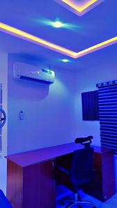 a room with a desk with a laptop on top of it at Annabelle & Annabelle Apartment in Abeokuta