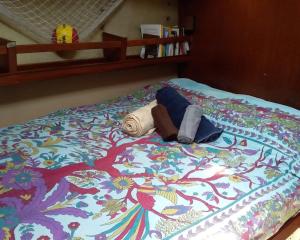 a bed with a colorful blanket on it at Play to Live San Blas in El Porvenir