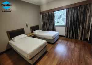 Giường trong phòng chung tại Copthorne Hilltop Resort, Sunrise n Mountain view at Cameron Highlands