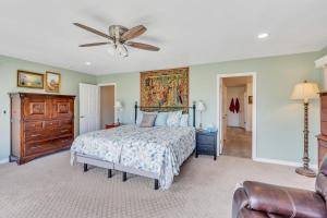 a bedroom with a bed and a ceiling fan at Over The River in Kinney Estates