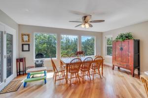 a dining room with a table and chairs and windows at Over The River in Kinney Estates