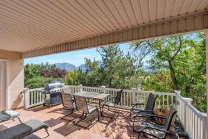 a patio with a table and chairs and a grill at Over The River in Kinney Estates
