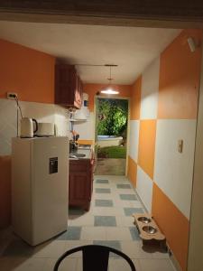 a kitchen with a refrigerator and a table in it at Con alma de Paraná, patio y estacionamiento propio in Paraná