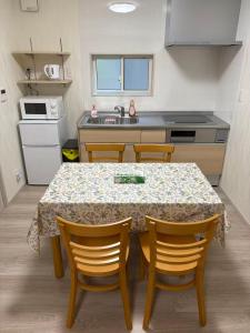 a kitchen with a table and chairs in a room at 富士晴 湖畔 Villas 湖景 in Fujikawaguchiko +23 photos