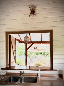 a kitchen with a sink and a window at Villa F3, Eden Krys, a cocoon of tranquility in La Trinité