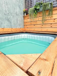 a swimming pool on a wooden deck with a bench at Up the Hill in Tiberias