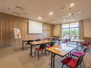 a conference room with tables and chairs and a screen at Mercure Aix-En-Provence Sainte-Victoire in Châteauneuf-le-Rouge +130 photos