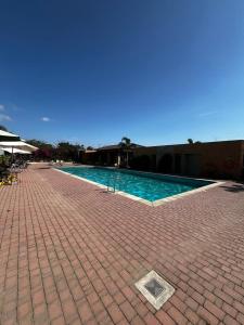 una piscina con pavimento in piastrelle e marciapiede in mattoni di Casa moderna en urbanización privada a Manta