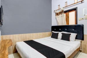 Postel nebo postele na pokoji v ubytování OYO 94881 Griya Barokah Syariah