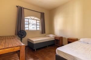 Ένα ή περισσότερα κρεβάτια σε δωμάτιο στο Casa 6 Quartos em Contagem - Ótima para Grandes Grupos