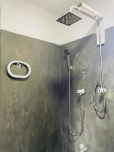 a shower with a shower head in a bathroom at Double G Motel in Weligama +59 photos