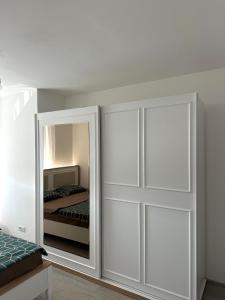 a bedroom with a closet with a mirror and a bed at ORG Apartment - Ferizaj in Ferizaj +3 photos