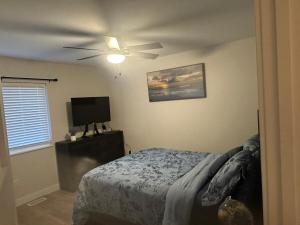 a bedroom with a bed and a ceiling fan at Luxurious Brand New Entire 3br and 2bath in Williston