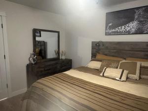 a bedroom with a large bed and a mirror at Luxurious Brand New Entire 3br and 2bath in Williston