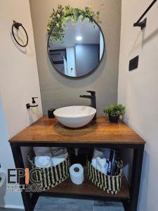 a bathroom with a sink and a mirror at Epic Suite 209 Deluxe Aeropuerto in Cuba +1 photo