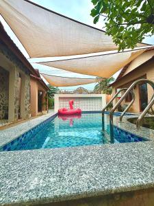 ein Schwimmbad mit einem roten Schwimmer darin in der Unterkunft Homestay Phú Mỹ in Phan Thiet