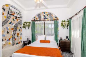 a bedroom with a bed and a large window at Maravida Boutique Hotel & Resort in Tamarindo +63 photos