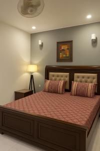 En eller flere senge i et værelse på Green Oasis