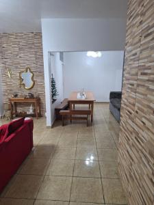 a living room with a table and a couch at RR 2 Pousada e Restaurante in Manaus +25 photos