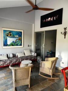 a living room with a couch and chairs and a ceiling fan at Cabaña privada con piscina y jacuzzi junto al mar in Santa Veronica
