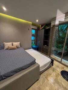 a bedroom with a bed and a window at Cabaña privada con piscina y jacuzzi junto al mar in Santa Veronica +24 photos